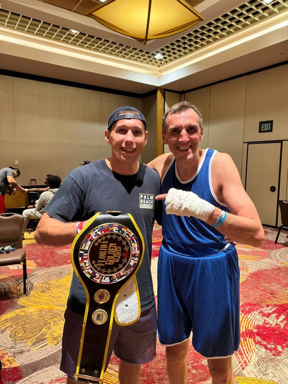 Artem Brusov with Palm Beach Championship belt — amateur boxing title
